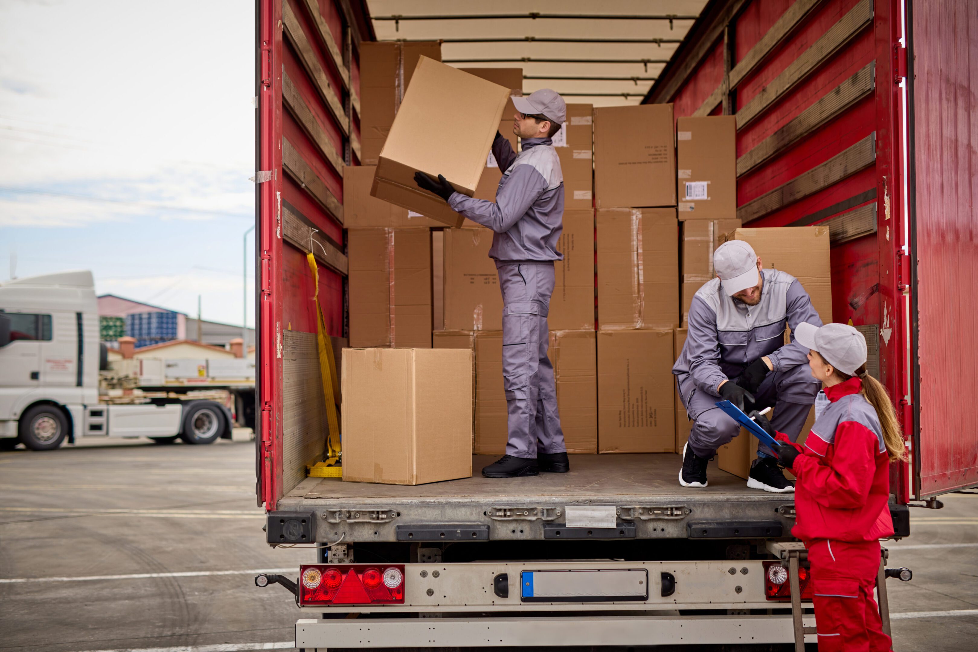 Workers loading boxes into a truck.